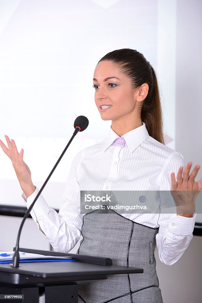 A woman standing at a lecturn